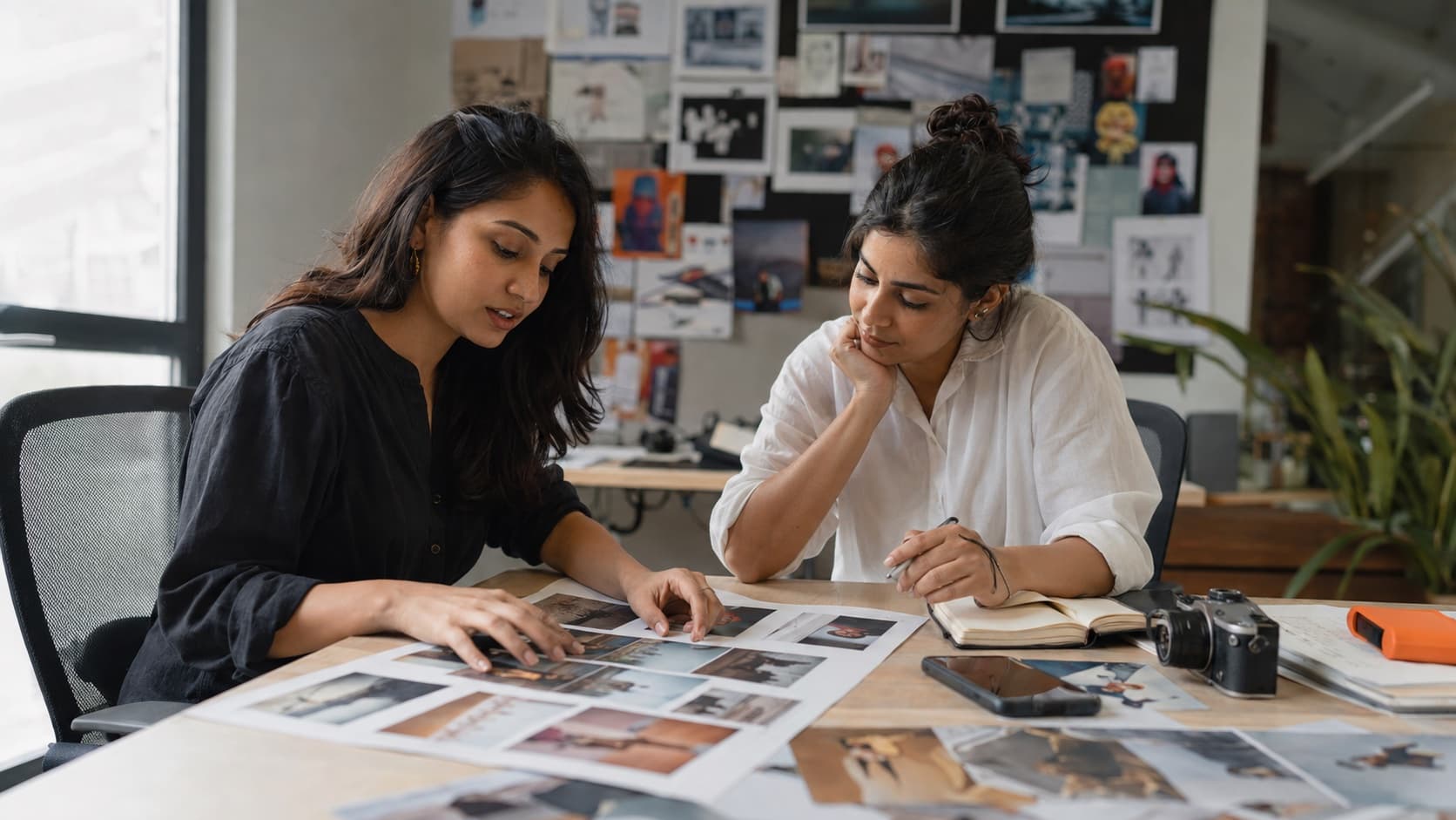 PUSHWebb social media team reviewing printed content for a posting calendar